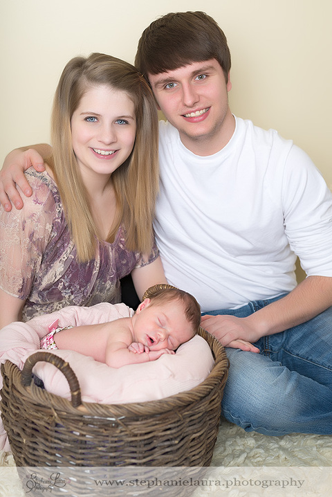 newborn in basket with parents