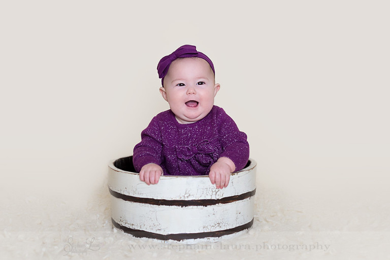 smiling 9 month old in basket